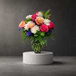 Mixed bouquet of roses and white daisies in a glass vase