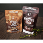 Two bags of chocolate-covered espresso beans on a wooden surface