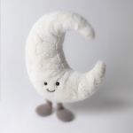 Plush crescent moon with a smiling face and small feet