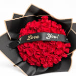 Red rose bouquet wrapped in black paper with a "I Love You!" ribbon