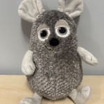 Gray plush animal toy with large eyes and antlers