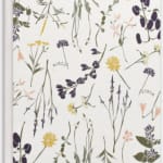 Floral-patterned paper with small purple, yellow, and peach blossoms