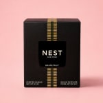 Black Nest New York grapefruit scented candle box on a pink background