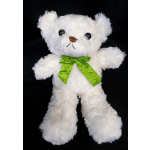 White teddy bear with a bright green ribbon on a black background
