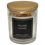 Glass candle jar with a wooden lid and black label reading Falling Leaves