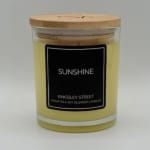 Yellow candle in a glass jar with a wooden lid
