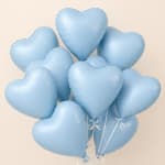 Cluster of light blue heart-shaped balloons with white ribbons