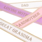 Decorative satin ribbons printed with family titles in pastel colors