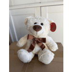 White teddy bear with a brown ribbon bow sitting on a box