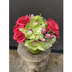 Pink roses and green orchids in a low vase arrangement