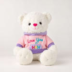 White teddy bear in a pink and purple shirt with "Love You Mom" text
