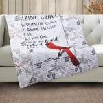 Quilted throw blanket with a red bird and printed text draped over a sofa