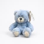 Blue plush teddy bear with a hanging gift tag