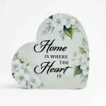 Heart-shaped home sign with white floral print and the words "Home is where the heart is"