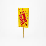 Yellow candy box pick on a wooden stick