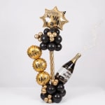 Gold and black New Year balloon arrangement with star and champagne bottle balloons