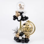 Graduation balloon display with black, white, and gold balloons