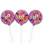 Three purple sprinkle lollipops with cartoon eyes on white sticks