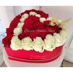 Red and white roses arranged in a heart-shaped box with a butterfly decoration