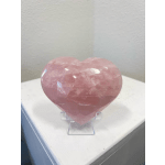 Pink heart-shaped crystal on a clear stand