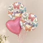 Birthday balloons with butterfly prints and a pink heart balloon