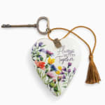 Heart-shaped floral ornament with a key and tassel