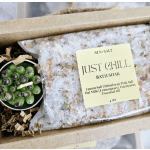 Gift box with bath soak and a small bowl of green olives