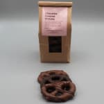 Bag of chocolate covered pretzels with a few pretzels in front