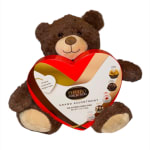 Brown teddy bear holding a heart-shaped Ferrero Collection chocolate box