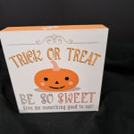 Halloween treat box with a pumpkin face and "Trick or Treat" text