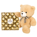 Teddy bear beside a box of Ferrero Rocher chocolates