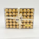 Box of Ferrero Rocher chocolates tied with a Dior ribbon