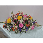 Large mixed bouquet with pink, yellow, and orange roses and small white filler flowers