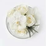 White floral bouquet in a clear round container