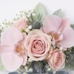 Soft pink roses and orchids arranged in a bridal bouquet