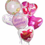 Cluster of heart-shaped anniversary balloons in pink and white
