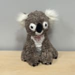 Plush koala toy with a glittery heart on its chest