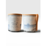 Two labeled candles in glass jars with wooden lids