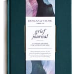 Teal grief journal with a white title band and abstract cover art