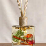 Glass reed diffuser with dried botanicals and cinnamon sticks