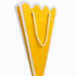 Yellow paper gift bag with white rope handles
