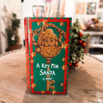 Holiday gift box labeled "A Key For Santa" with a decorative Santa face
