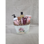 Grapefruit-scented bath gift set arranged in a floral metal pail with crinkle paper filler