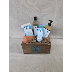 Wooden gift crate with sea salt bath products, lotions, sponge, and a blue bath bomb