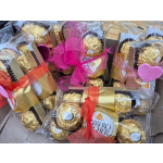 Gift packs of Ferrero Rocher chocolates tied with colorful ribbons