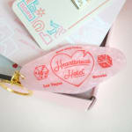 Pink keychain with a heart and "Heartbreak Hotel" text