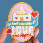 Hand holding a Las Vegas sticker with a castle and heart design