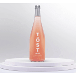Bottle of TÖST rosé sparkling beverage on a white pedestal