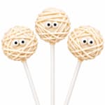 Three mummy-themed cake pops on white sticks against a white background