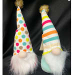 Two small gnome figurines with tall patterned hats and fluffy beards